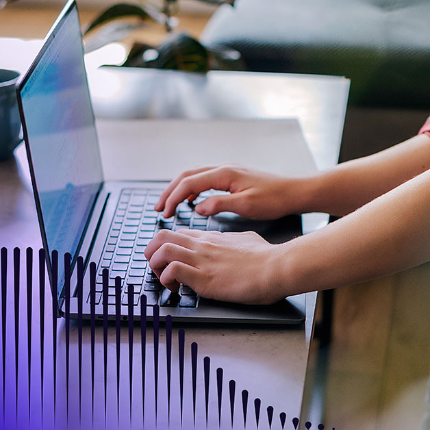 Hands typing on laptop