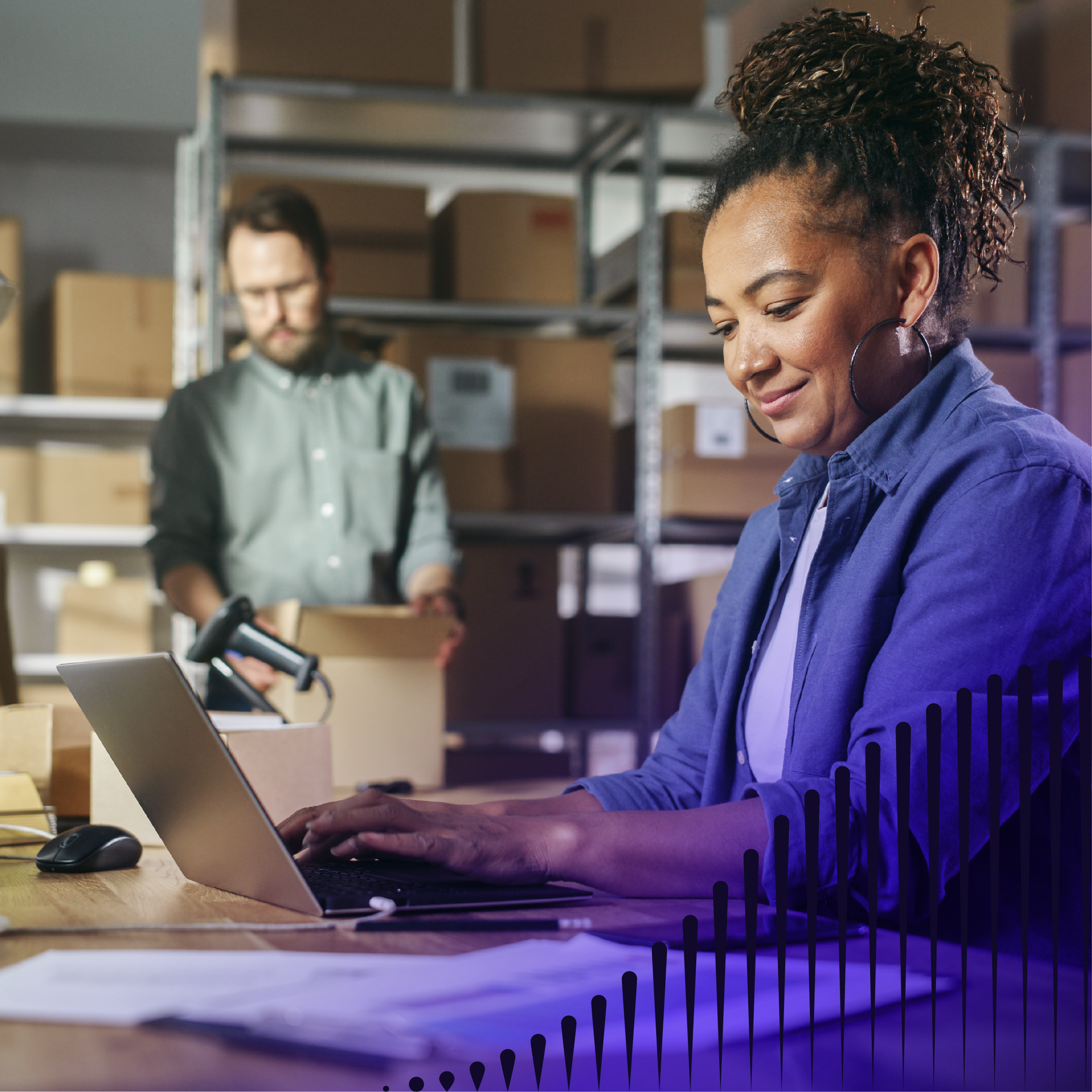 Woman working on her laptop with man working in the background