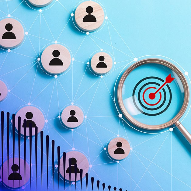 Person icons beside a magnifying glass that has a target on it