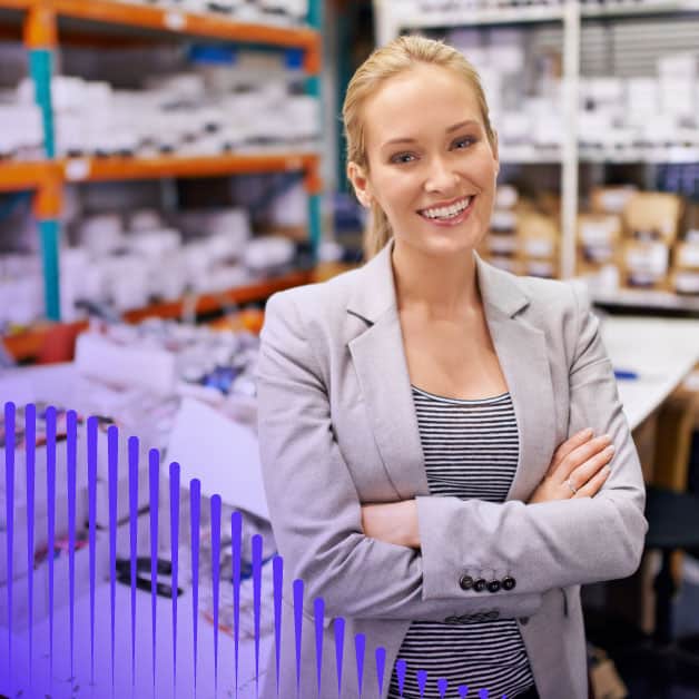 Woman standing at a bar smiling and crossing her arms