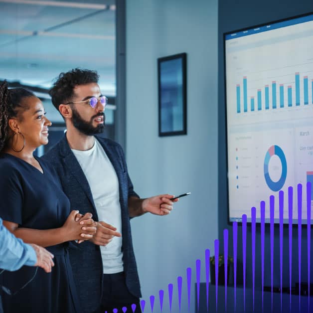 Man and woman looking at a screen with charts on it